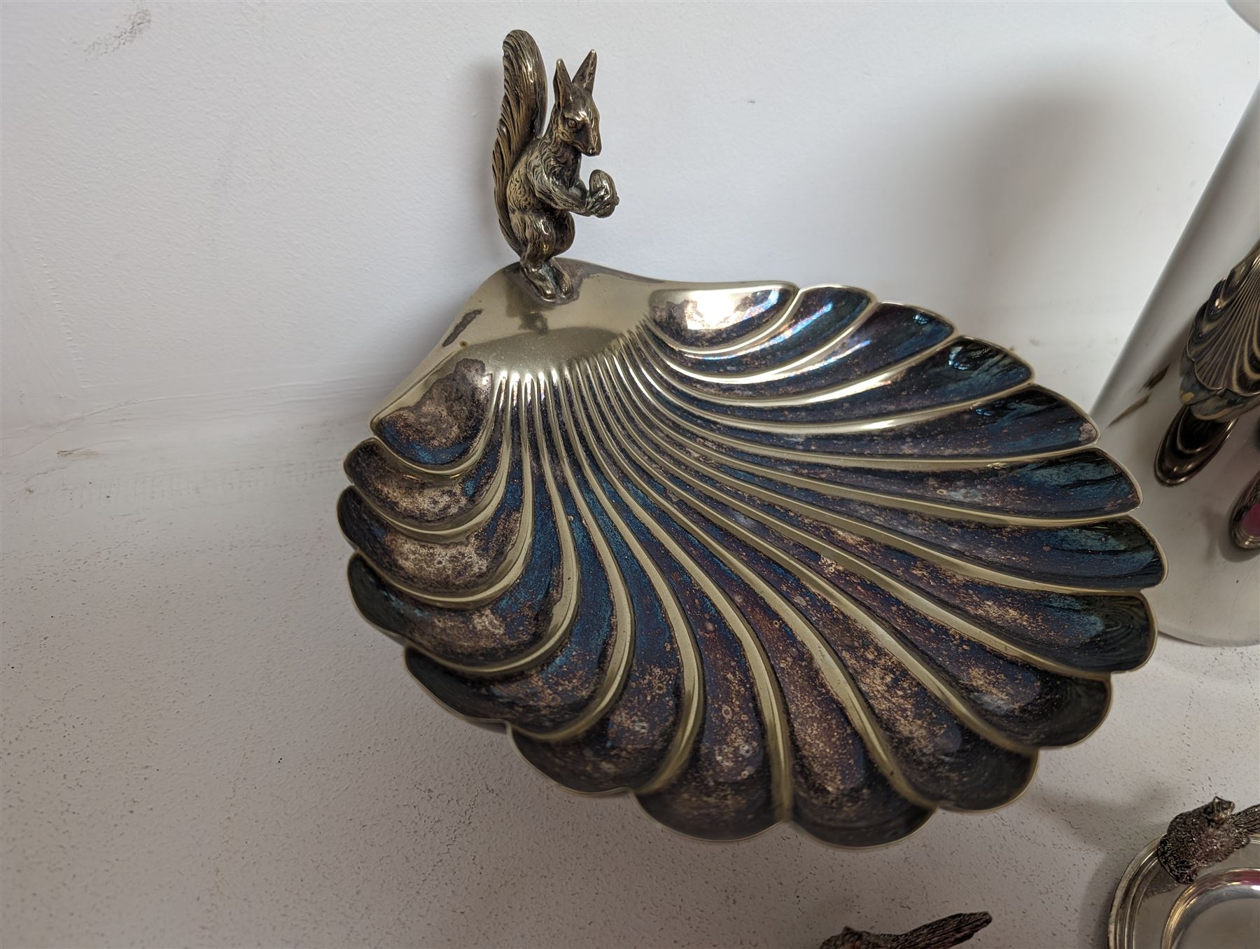 George Jensen stainless steel wine cooler, together with a silver plated pedestal dish, in the form of a clam shell and with squirrel decoration and four silver plated trinket dishes with applied pheasant decoration