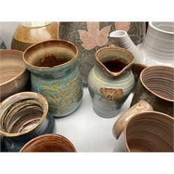 Wold studio pottery tankards, in various colours and relief decoration together with other studio items including vases, jugs and pots 