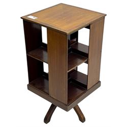 Edwardian inlaid mahogany revolving bookcase, square top, two tier open book compartments, on a cruciform base with splayed feet 