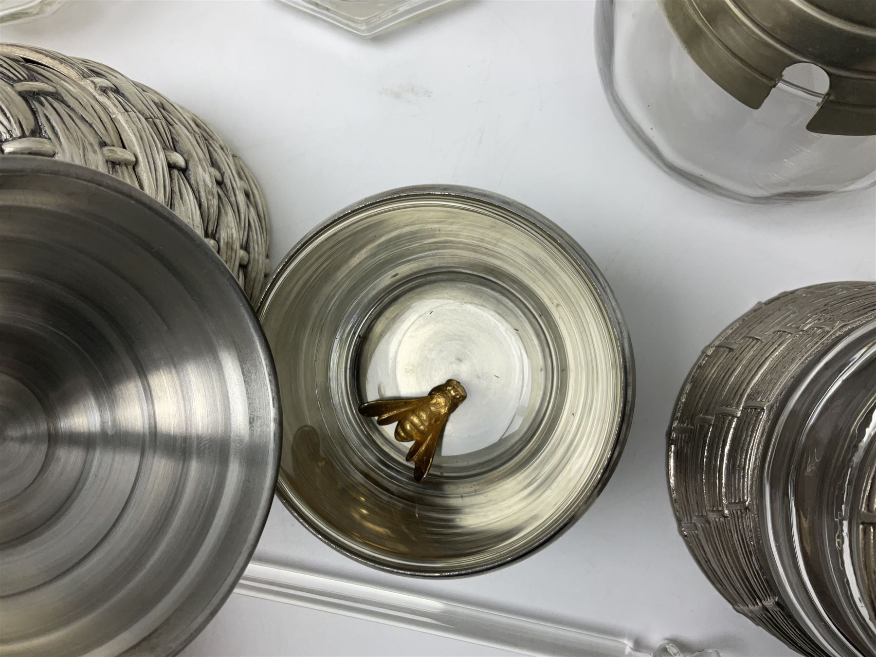Collection of glass beehive honey pots, to include a blue slag example, milk glass, pink, green, etc together with four white metal examples (16) 