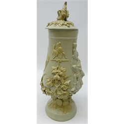  19th/ early 20th century Continental salt glaze/ stoneware footed vase and cover, decorated in relief with Bacchanal and Toping scenes with applied hops and barley & figures drinking (a/f) H40cm   