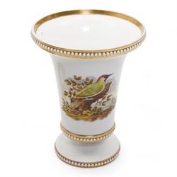 Early 19th century Spode spill vase, of cylindrical form with flared rim, hand painted with a Green Woodpecker perched on a branch, within beaded borders, titled beneath, H16cm, together with a Spode chocolate cup turnover rim stand, decorated in the imari pattern, no. 2630, painted marks beneath, D14cm (2)