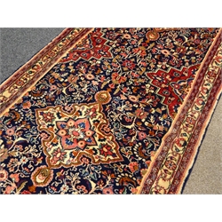  Persian Hamadan runner rug, blue ground field with five medallions, overall interlacing floral design with stepped spandrels, three band border with scrolled decoration, 108cm x 580cm  