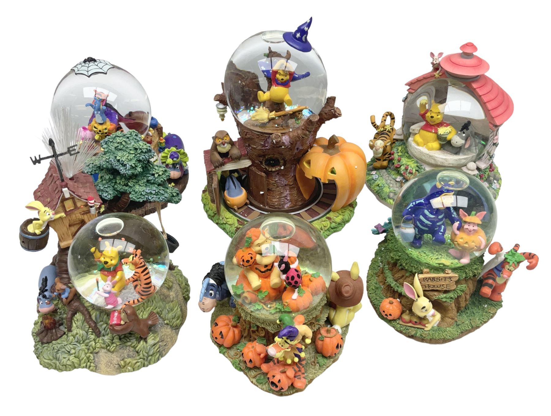 Six Disney Winnie The Pooh snow globes, to include four Halloween examples, including Tigger's Haunted House, together with Winnie The Pooh Gazebo snow globe and Bonfire snow globe, all with boxes