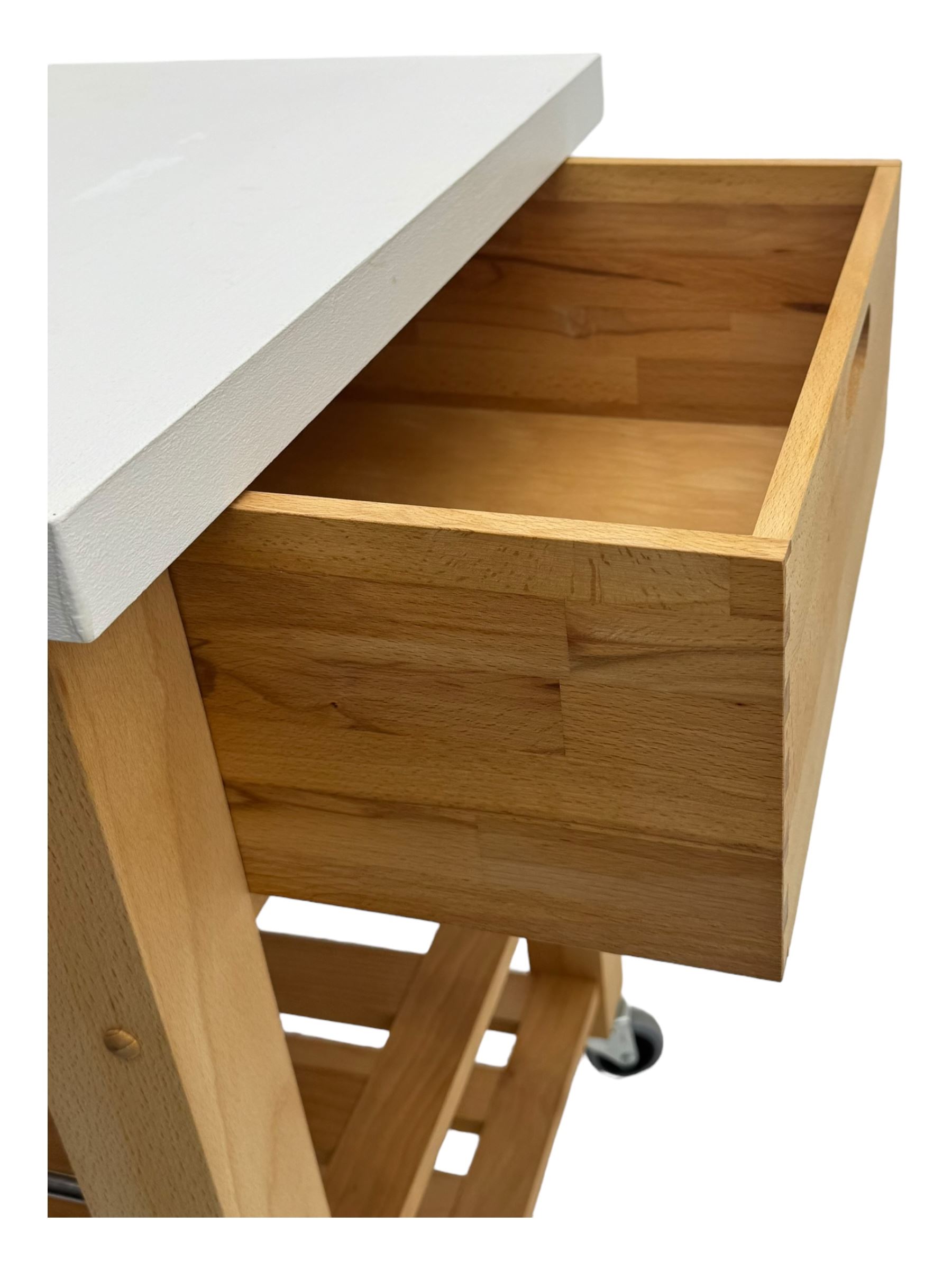 Contemporary butchers block kitchen trolley, white square top over beech frame, single pull-out drawer, dual slatted shelves, chrome towel rails, raised on square supports with castors