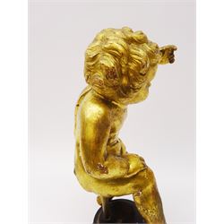 Early 18th century giltwood and gesso figure, carved in the form of a putto, upon later ebonised circular stepped base, H30cm