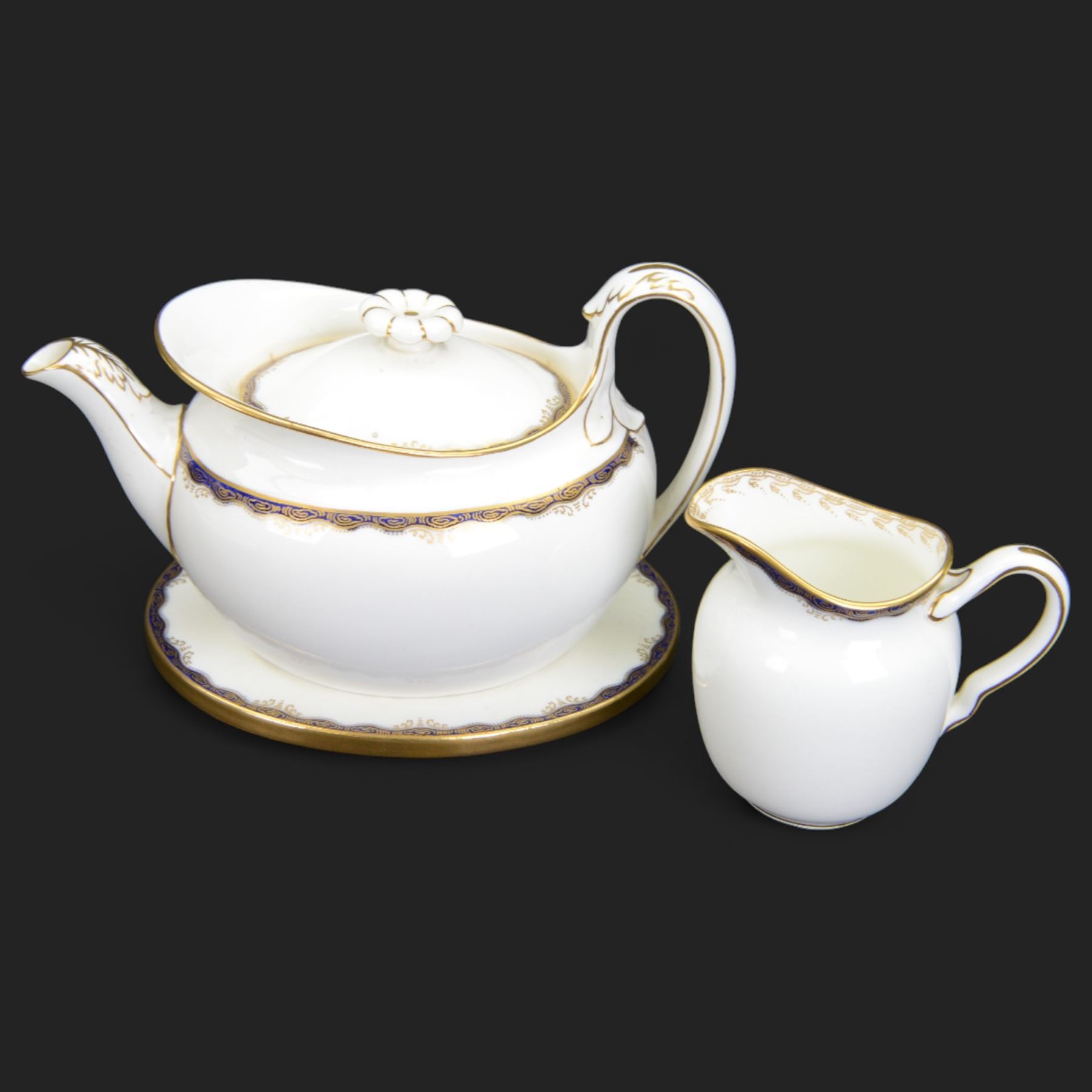 Wedgwood tea service, comprising teapot and stand, hot water jug, milk jug, open sucrier, twelve side plates, two sandwich plates, twelve cups and eleven saucers 