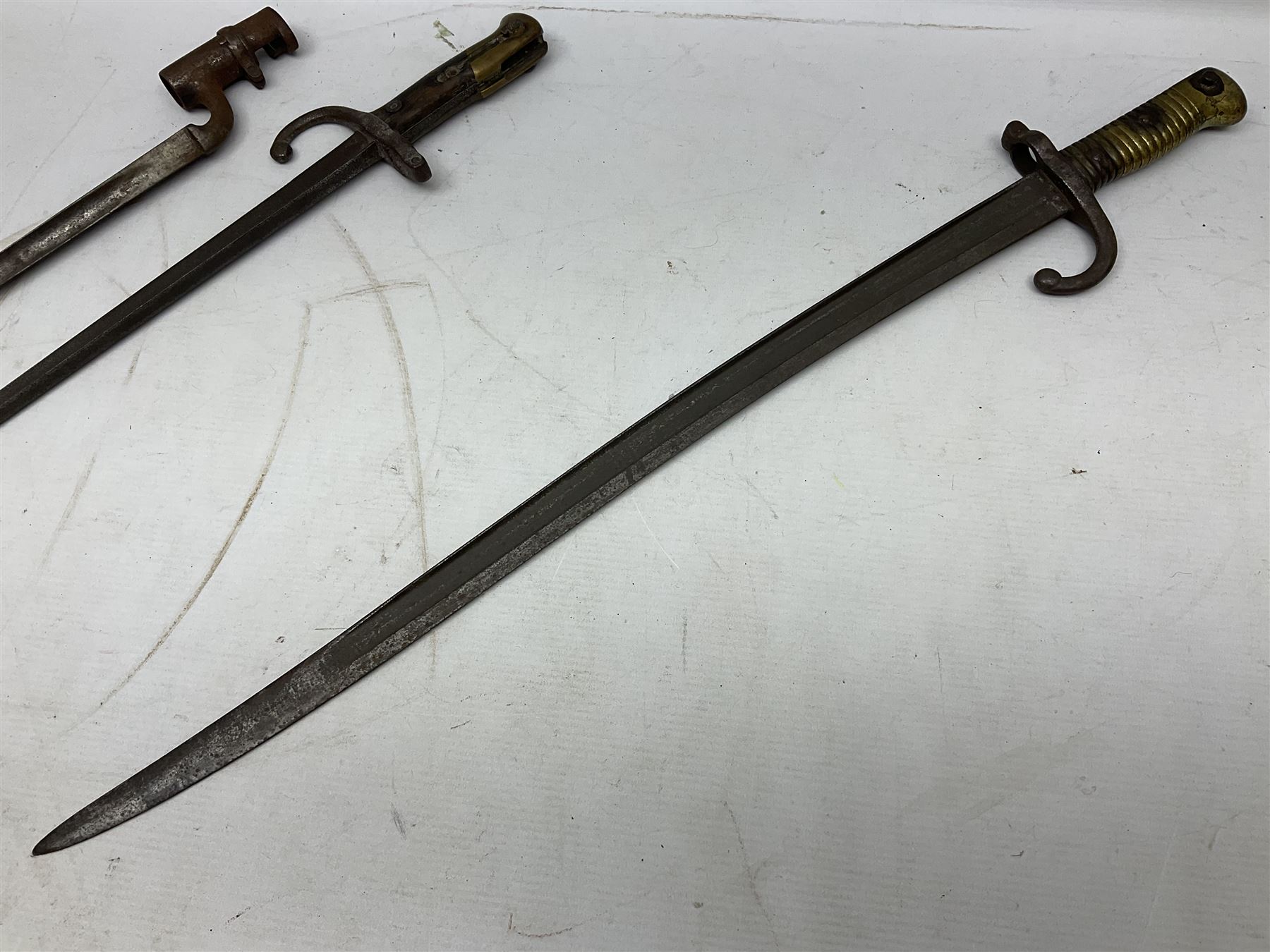 Five 19th century bayonets in relic condition without scabbards comprising British Pattern 1876 socket bayonet with Indian markings; French Model 1874 epee bayonet; and three French Model 1866 sabre bayonets (5)