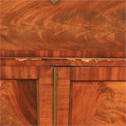 Early 19th century mahogany secretaire-bookcase, projecting cornice above astragal glazed cabinet with adjustable shelved interior, fall front secretaire drawer, fitted interior with pigeonholes and drawers, flame mahogany fronted cabinet with three drawers, on turned supports 