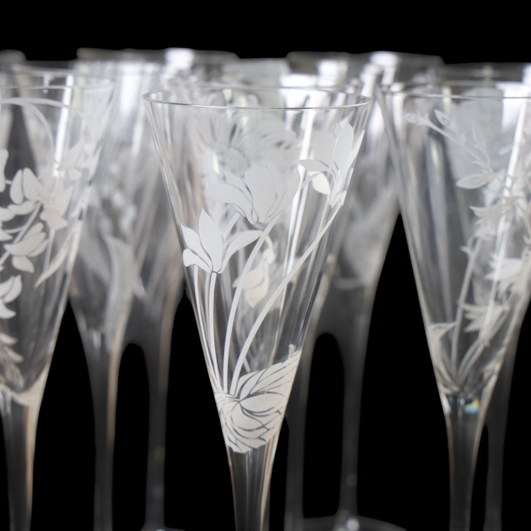 Twelve Crystal champagne glasses Les Fleurs, issued by the Franklin Mint in collaboration with Perrier Jouet, each glass is etched with a different flower, all boxed 