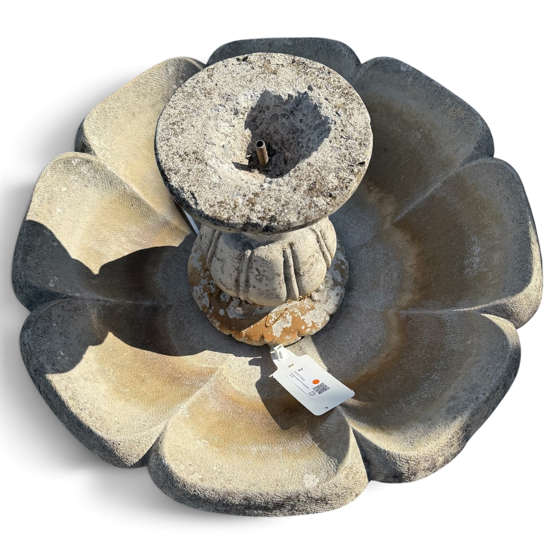 Weathered cast stone garden water feature fountain, the raised central spout with egg-and-dart moulding, within a scalloped basin raised on a lappet pedestal with cylindrical plinth base