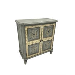 Painted side cabinet, fitted with two cupboard doors with panelled fronts enclosing shelf, painted with tulip and scrolling foliate design, chamfered uprights raised on turned feet, in white and grey-blue finish