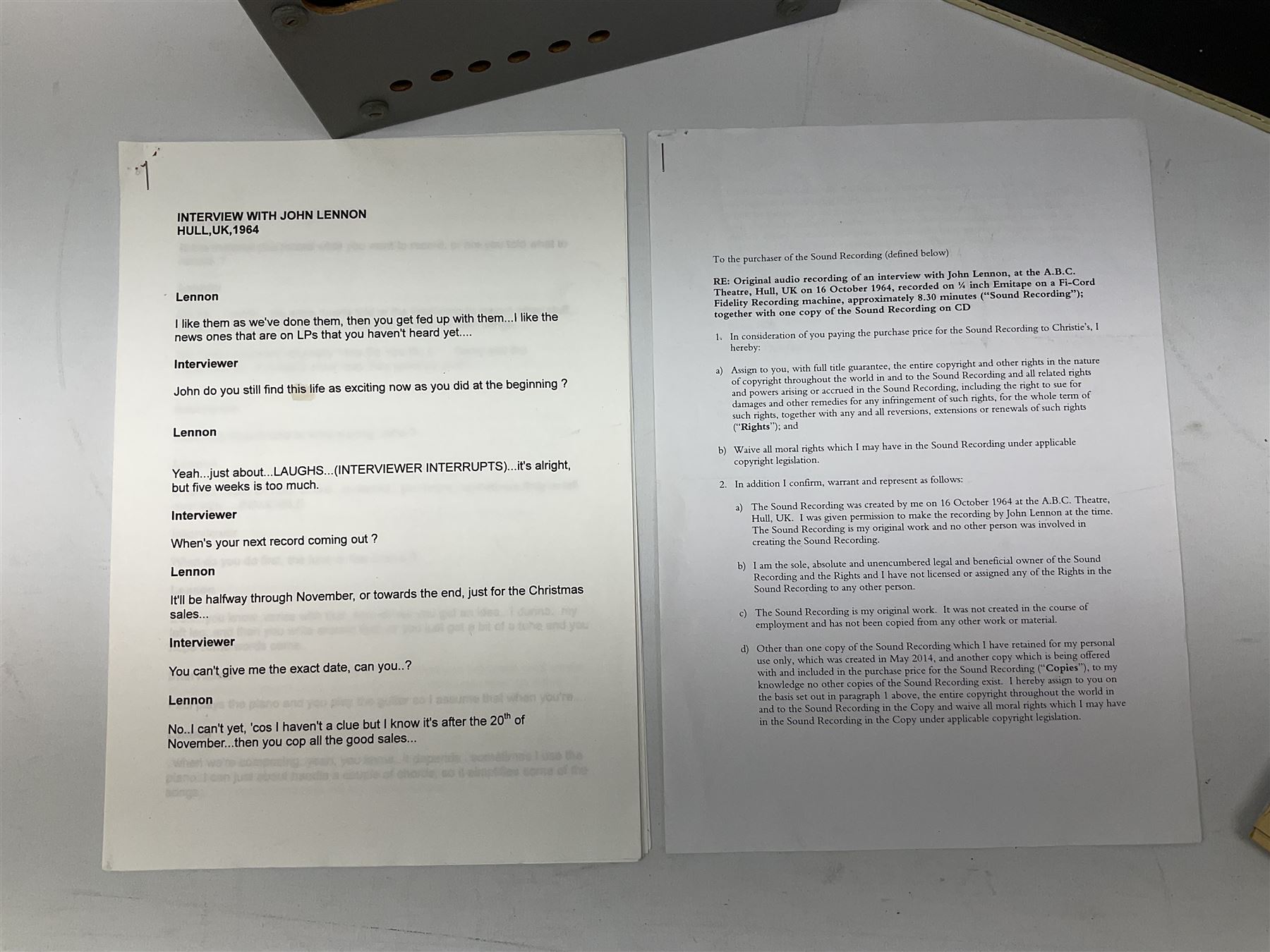 John Lennon interview recording conducted by John Hill student of Hull University on the 16th October 1964 at the A.B.C. Theatre Hull on behalf of the university newspaper 'Torchlight'. The interview lasts eight and a half minutes. It catches John in an upbeat breezy mood answering questions about the following topics: the song writing process ('sometimes you get an idea ....I dunno....my left leg.... and then write about that....'), recording (.... 'they just say - you're recording on such and such a date and they hope we turn up with some good songs written ....'), an alternative career path (.... 'I'd probably just have been a lay-about....'), failing at college (....'some other lads did my exams for me ....'), reading matter ( Clockwork Orange, Alice in Wonderland), his books of prose, tastes in music, the Blues, The Rolling Stones, being a Beatle vis-a-vis anonymity ('Whatever I'd be I'd choose to be rich .... who wants to walk down the street?').
The interview was recorded on 1/4 inch Emitape on a Fi-Cord Fidelity Recording machine. The reel-to-reel tape comes in its original Emitape plastic box and is accompanied by the Fi-Cord reel-to-reel machine on which the interview was originally recorded. Also included in this lot are a copy of the 'Torchlight' newspaper from 21st November 1964, two photographs of the interviewer with John Lennon (the interviewer is pictured to the left of John Lennon in the photograph in which John is signing a sketch) and one photograph of Paul McCartney with another reporter, the largest measures 12 x 16.5cm and a transcript of the interview. The recording is also accompanied by the original Fi-Cord tape recorder with microphone, four original 2v batteries and battery charger. The tape recorder has been adapted to take 3xAA batteries and the 2v battery charger is fitted with a standard UK 3-pin AC plug. The interview was recorded in the press room prior to the Beatles concert at the A.B.C. Theatre and is sold with copyright.