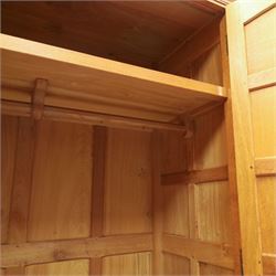 Beaverman - oak double wardrobe, enclosed by twin multi-panelled doors, Yorkshire Rose carved handles, the interior fitted with shelf and hanging rail, with signature carved beaver, by Colin Almack of Sutton, near Thirsk