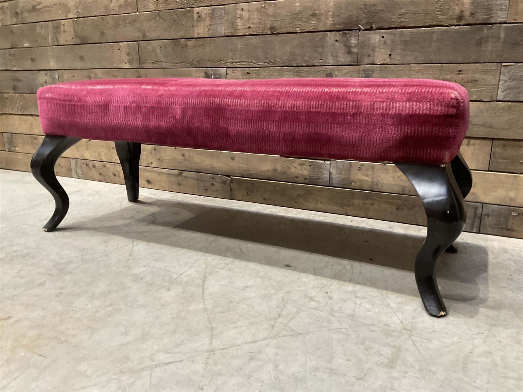 Large rectangular footstool upholstered in a maroon fabric with cabriole supports