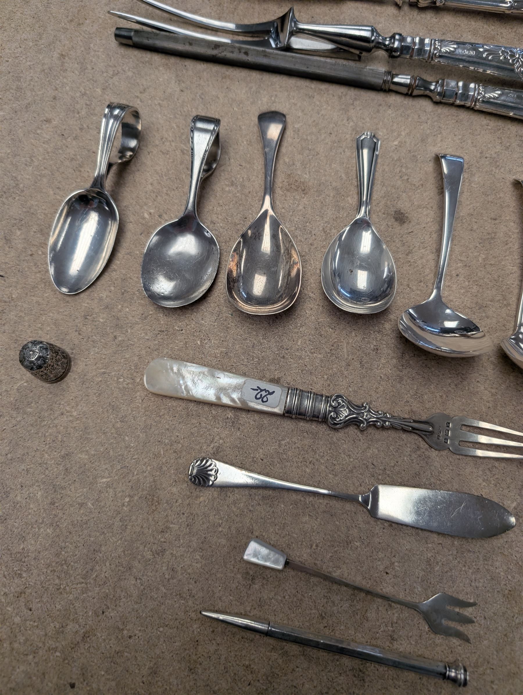 Group of silver and silver handled cutlery, including caddy spoons, thimble, propelling pencil, fruit knife, etc, all stamped or hallmarked