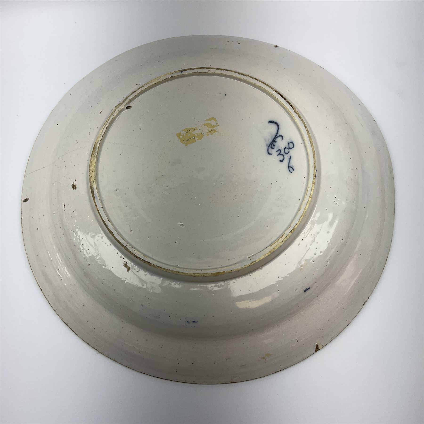 18th century Delft blue and white peacock pattern dish, painted with a fan of peacock feathers behind an urn of fruit and flowers, D34.5cm. 