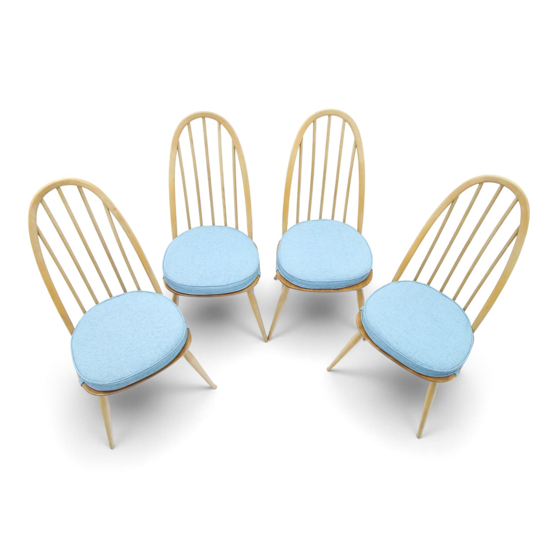 Ercol - set of four 'Quaker' dining chairs, with high hooped back, blue seat cushions with studded, tapered supports  