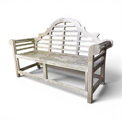 Lutyens design teak garden bench, shaped arched and slatted back over rolled arms and slatted seat, raised on square supports with box-stretcher