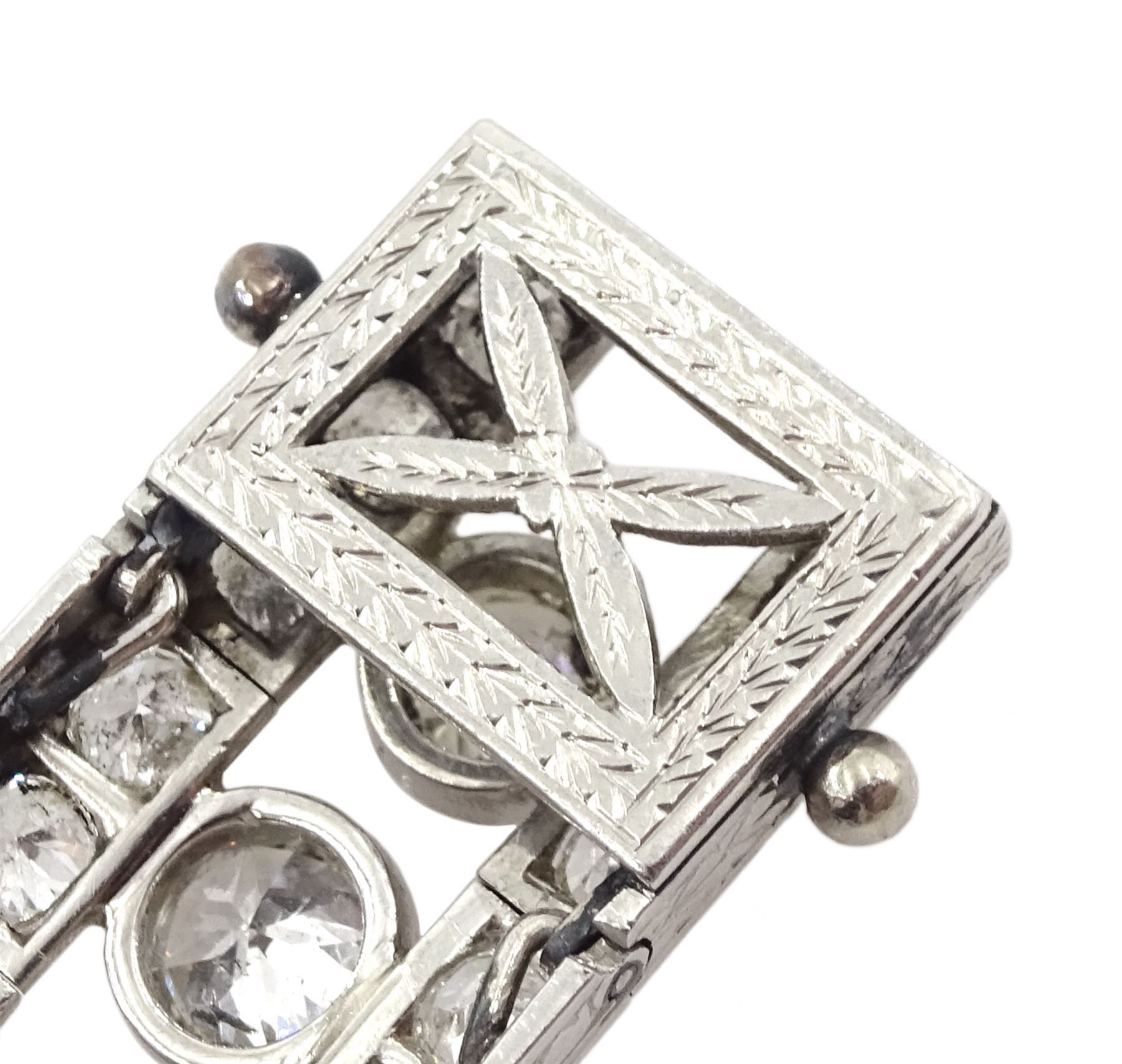 Continental Art Deco platinum old cut diamond openwork bracelet, circa 1920's, twenty-two bezel set graduating diamonds of approx 9.45 carat, the principal diamond approx 0.90, with a row milgrain set diamonds either side, the clasp set with a single diamond, the bracelet sides and clasp with engraved foliate decoration, total diamond weight approx 20.60 carat