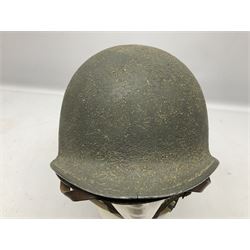 American first type paratrooper helmet with post-WW2 strap and D-rings and later 1944 liner bearing Firestone Tyre and Rubber Company mark; green textured finish