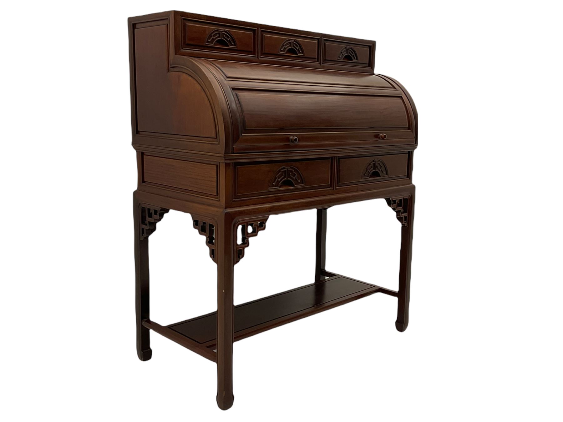 Hardwood cylinder desk, three drawers raised over curved lid, fitted interior with slide, the supports joined by undertier with fret work brackets 