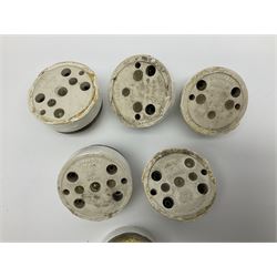 Six early 20th century brass toggle light switches, with painted ceramic base, D5.5cm