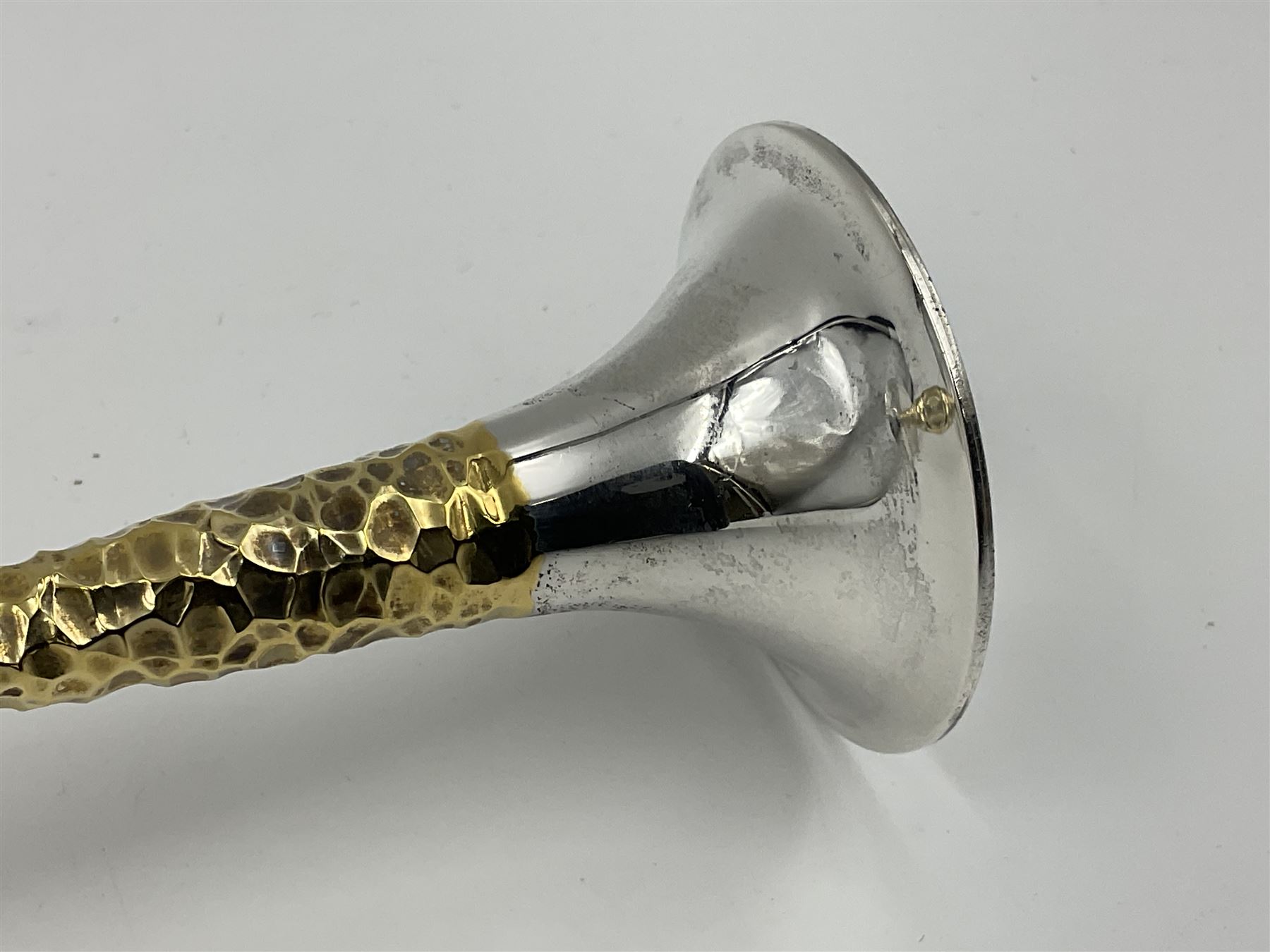 Pair of modern silver candlesticks by Stuart Devlin, the tapering parcel gilt stems with signature textured detailing, each supporting a fluted candle holder and upon a spreading circular foot, hallmarked Stuart Devlin, London 1973, H25cm