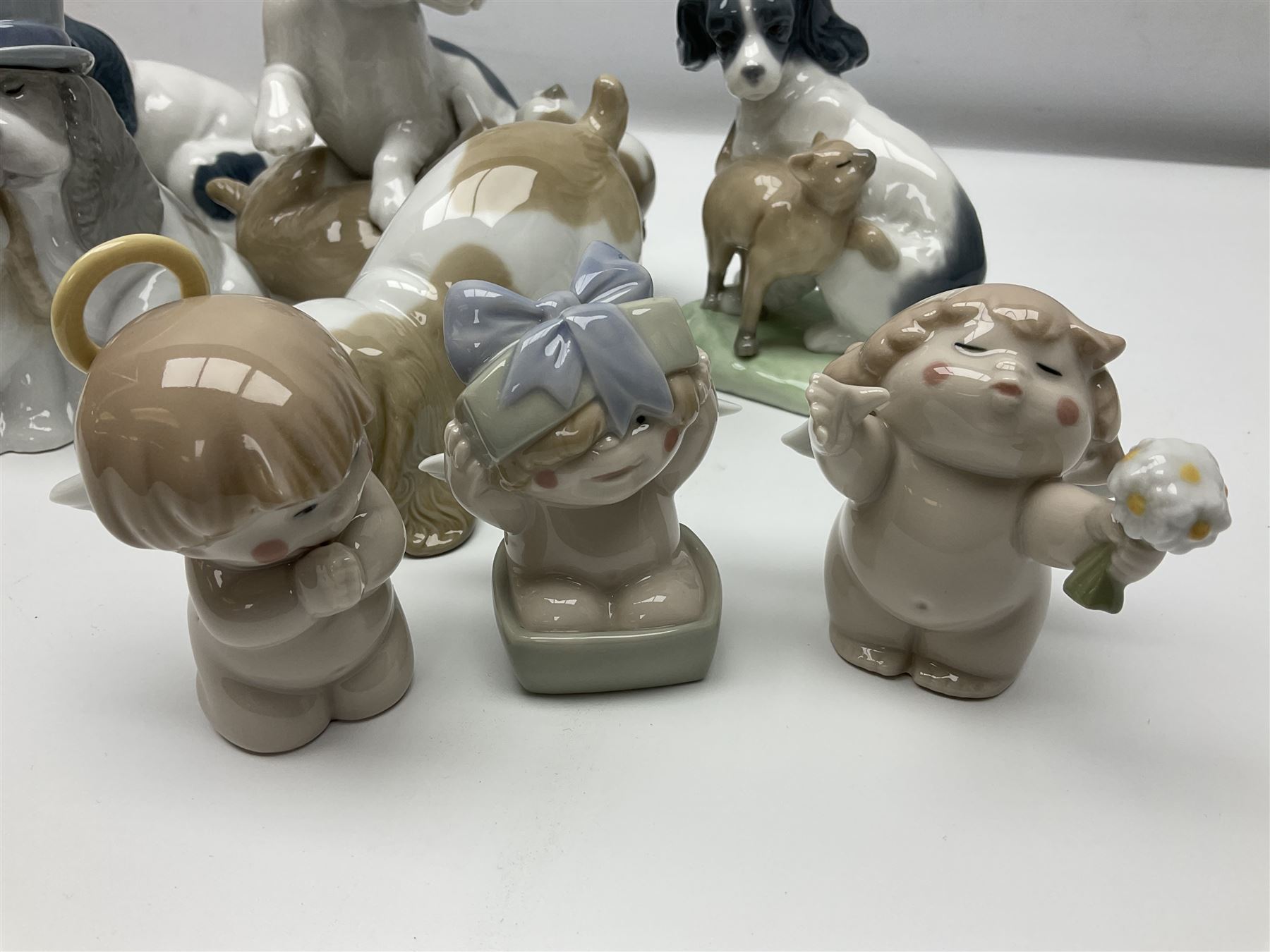Ten Nao figures, to include three Cheeky Cherubs, Cat, Dog bride and groom etc