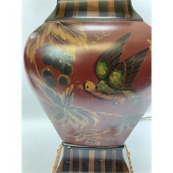 Pair Oriental table lamps decorated with birds in a tree with fruit, on a red ground with a gilded base together with cream lampshades H57cm, without lampshade. 