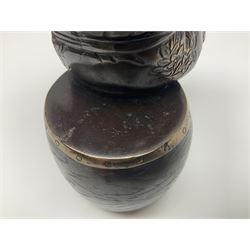 Oriental bronze figure of a gentleman, modelled seated upon barrel with a pipe in one hand and a flask in the other, H21cm