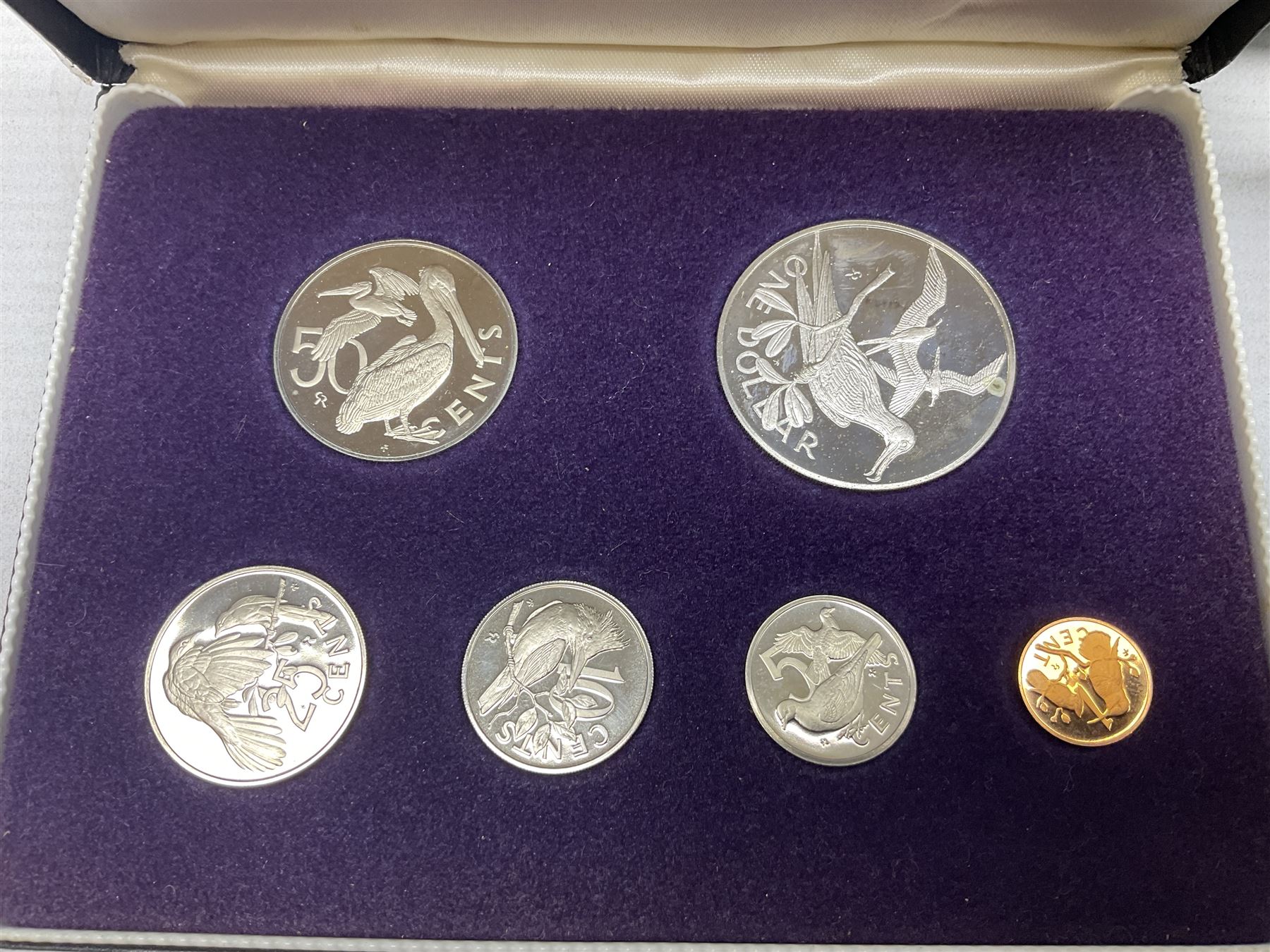 The Royal Mint United Kingdom 1977 silver proof two coin set, Queen Elizabeth II 2002 silver proof three coin set, comprising Bailiwick of Jersey, Bailiwick of Guernsey, and Alderney five pound coins, 'First Coinage of the British Virgin Islands' proof set, 1997 1/10 ounce fine silver Britannia, two King George V 1935 'Rocking Horse' crowns, various Isle of Man commemorative crowns, etc., house in a hard shell carry case
