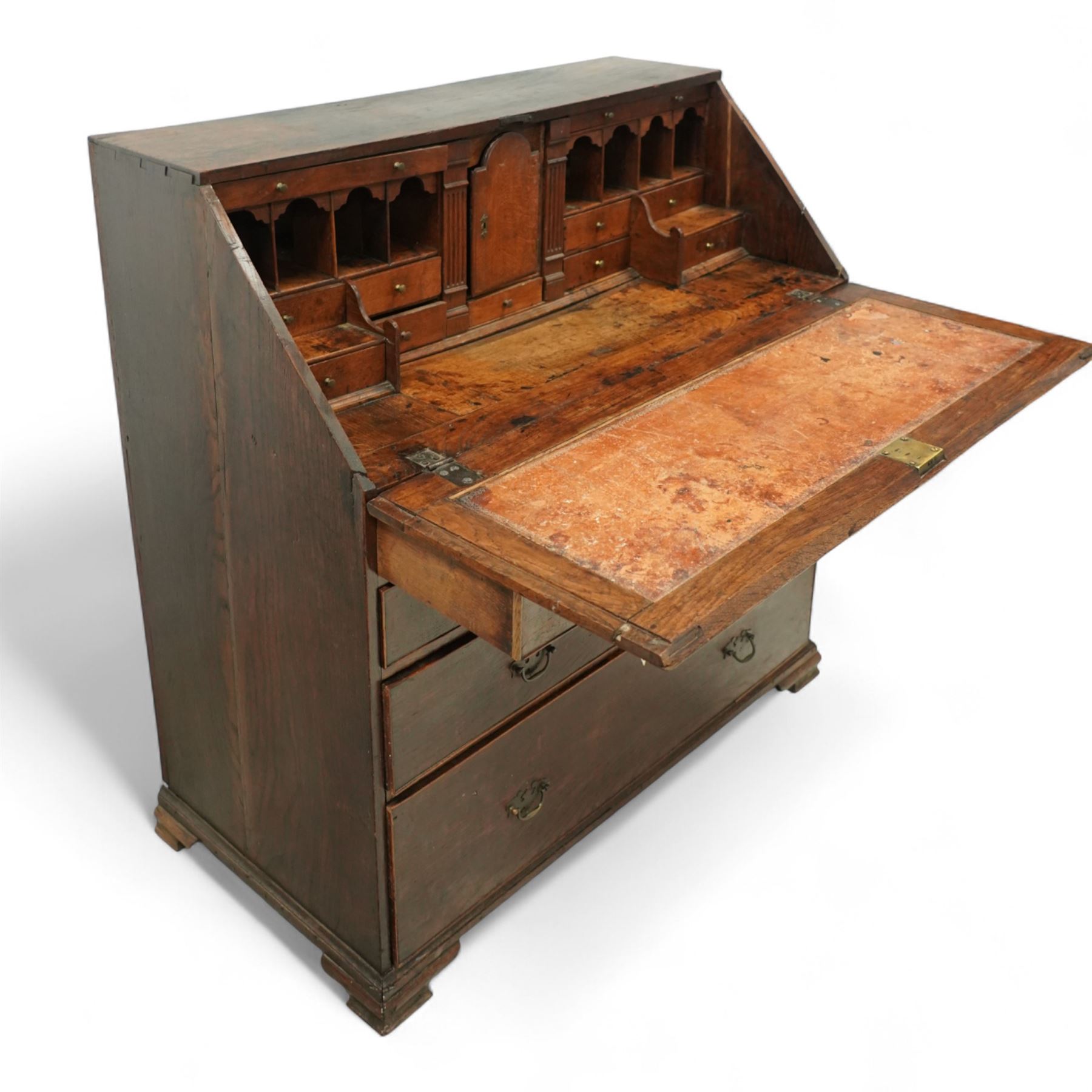 George III oak bureau, the fall front enclosing a fitted interior of small drawers and pigeonholes, above seven graduated drawers with brass plate handles and bone escutcheons, raised on bracket feet
