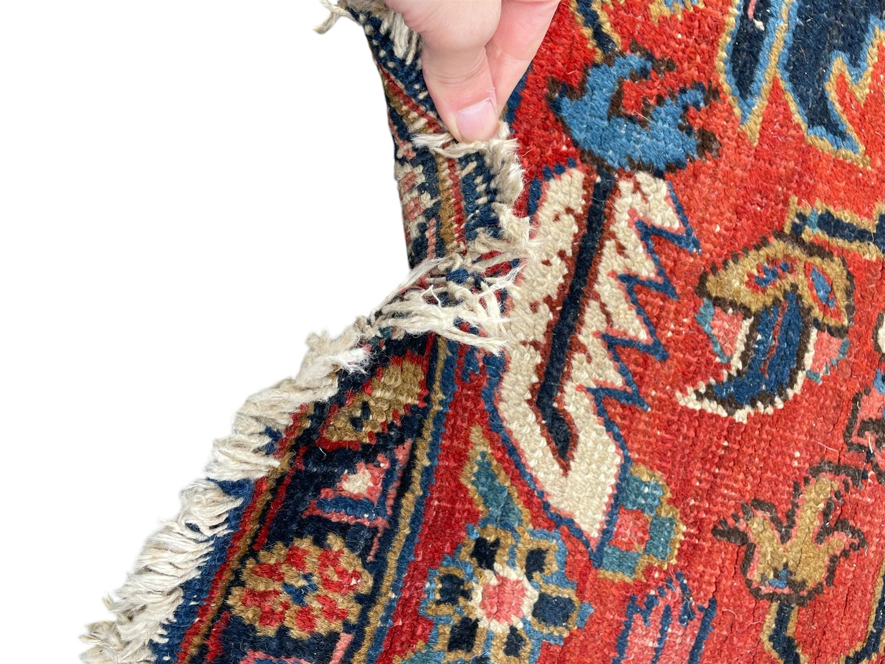 Persian blue ground carpet, the field divided up into panels by trailing bands with flower heads, each panel decorated with palmettes and stylised plant motifs, the border decorated with further palmettes, within floral pattern guard stripes 