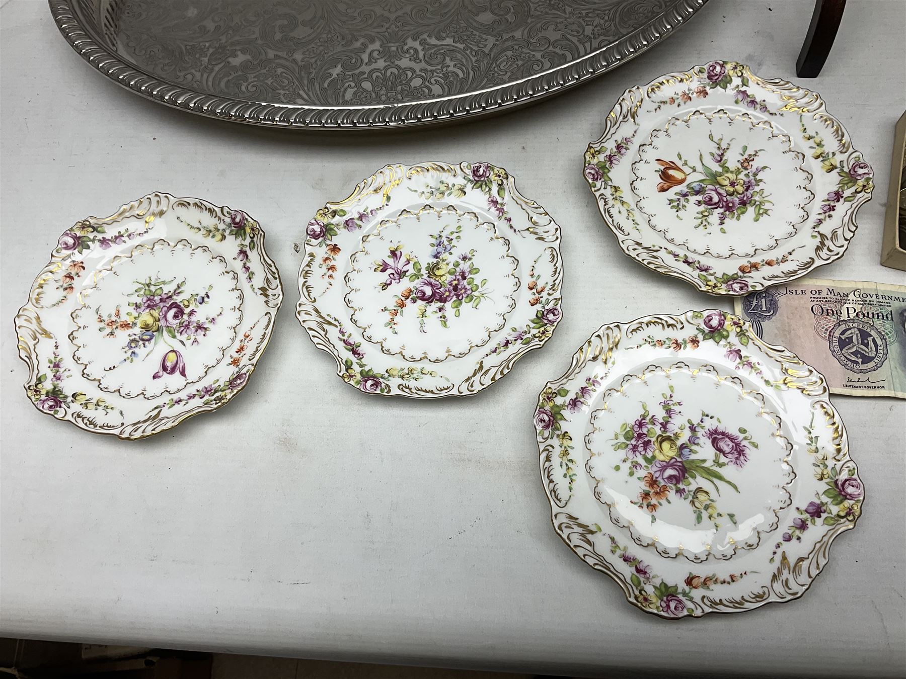 Set of four Dresden dessert plates hand painted with flowers and gilt scrolls, together with silver plate serving dish, a mahogany folding cake stand and a collection of coins