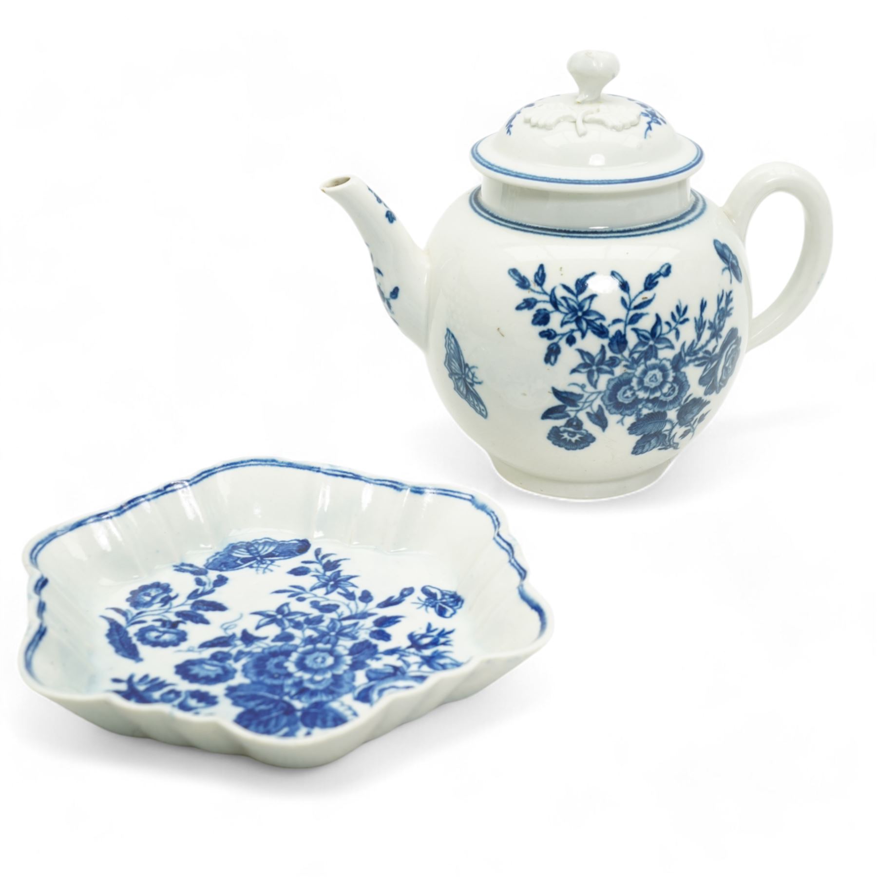 First Period Worcester porcelain teapot decorated in the Three Flowers pattern, with flower knop handle, H15cm and Worcester fluted dish decorated in the same pattern, both with cresent marks beneath (2)