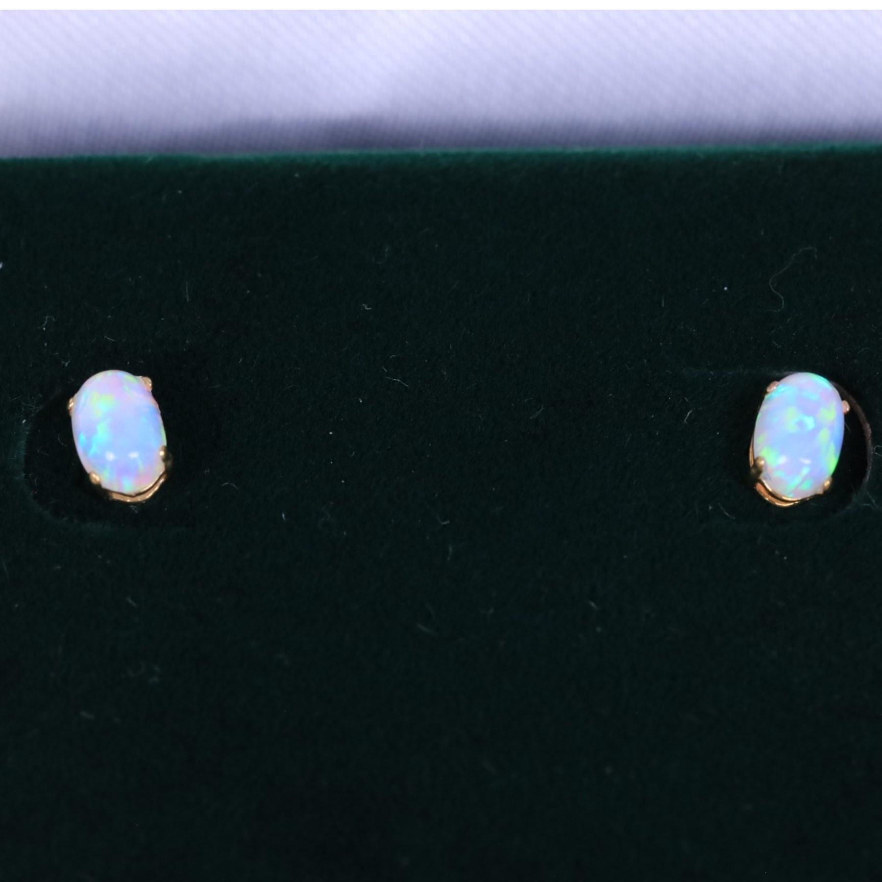 Pair of 9ct gold oval opal stud earrings, boxed