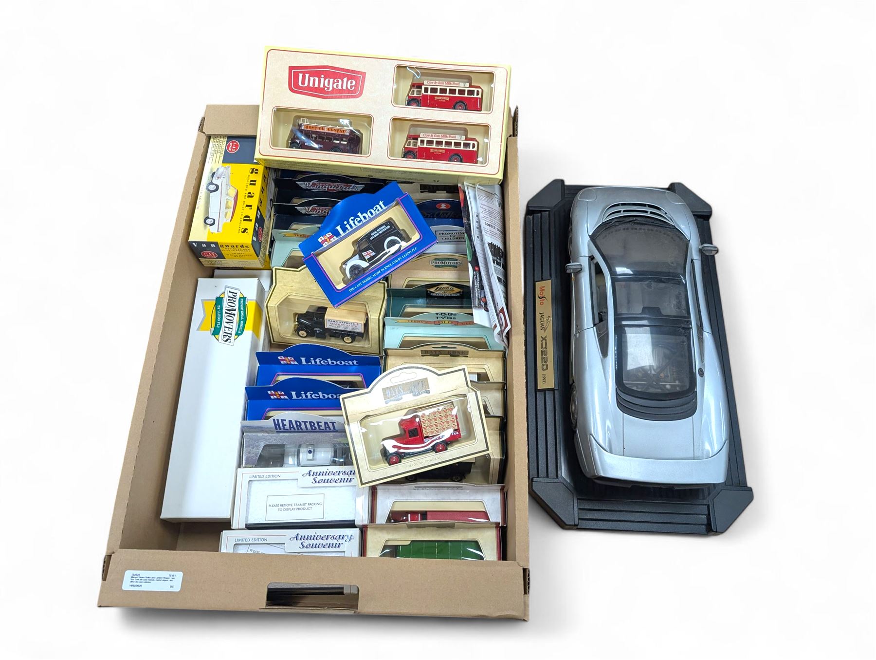 Maisto Jaguar XJ220 model car on stand and a collection of diecast model vehicles, including Vanguards, Unigate and Lledo examples