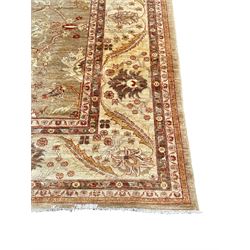 Pakistani ivory ground carpet, the field decorated with leaf branches, lotus flowers and roses, wide guarded border long leaves and stylised plant motifs