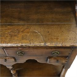 Georgian design oak dresser of small proportions, moulded cornice over open plate rack with two shelves and shaped apron, the base fitted with two drawers over three small drawers, brass drop handles, shaped apron, on square supports united by pot board