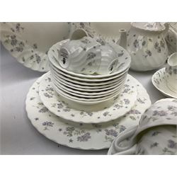 Wedgwood tea and dinner service decorated in the ‘April Flowers’ pattern, to include nine bowls, seven teacups and saucers, three coffee cups and saucers, sauce boat and stand, lidded tureen, covered sucrier and another smaller, oval serving plate, twelve side plates, teapot, four dinner plates, jug and shallow bowl