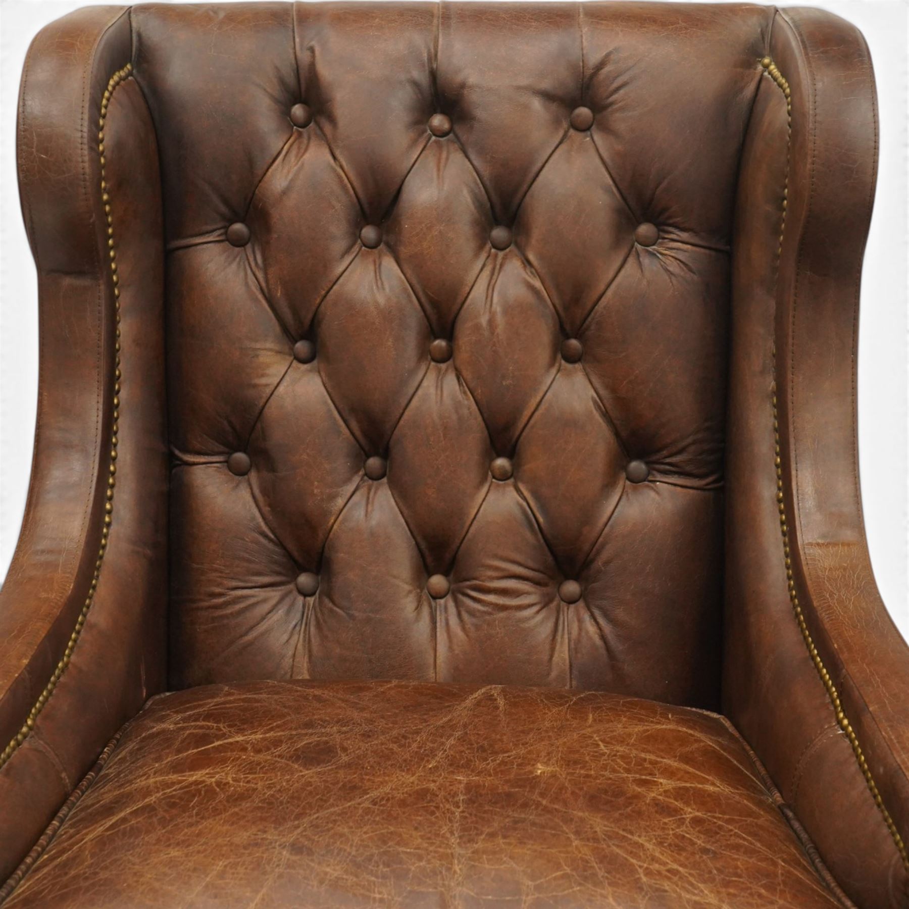 Timothy Oulton - pair of wingback armchairs upholstered in back-buttoned chocolate brown leather with loose seat cushion, raised on square tapering feet