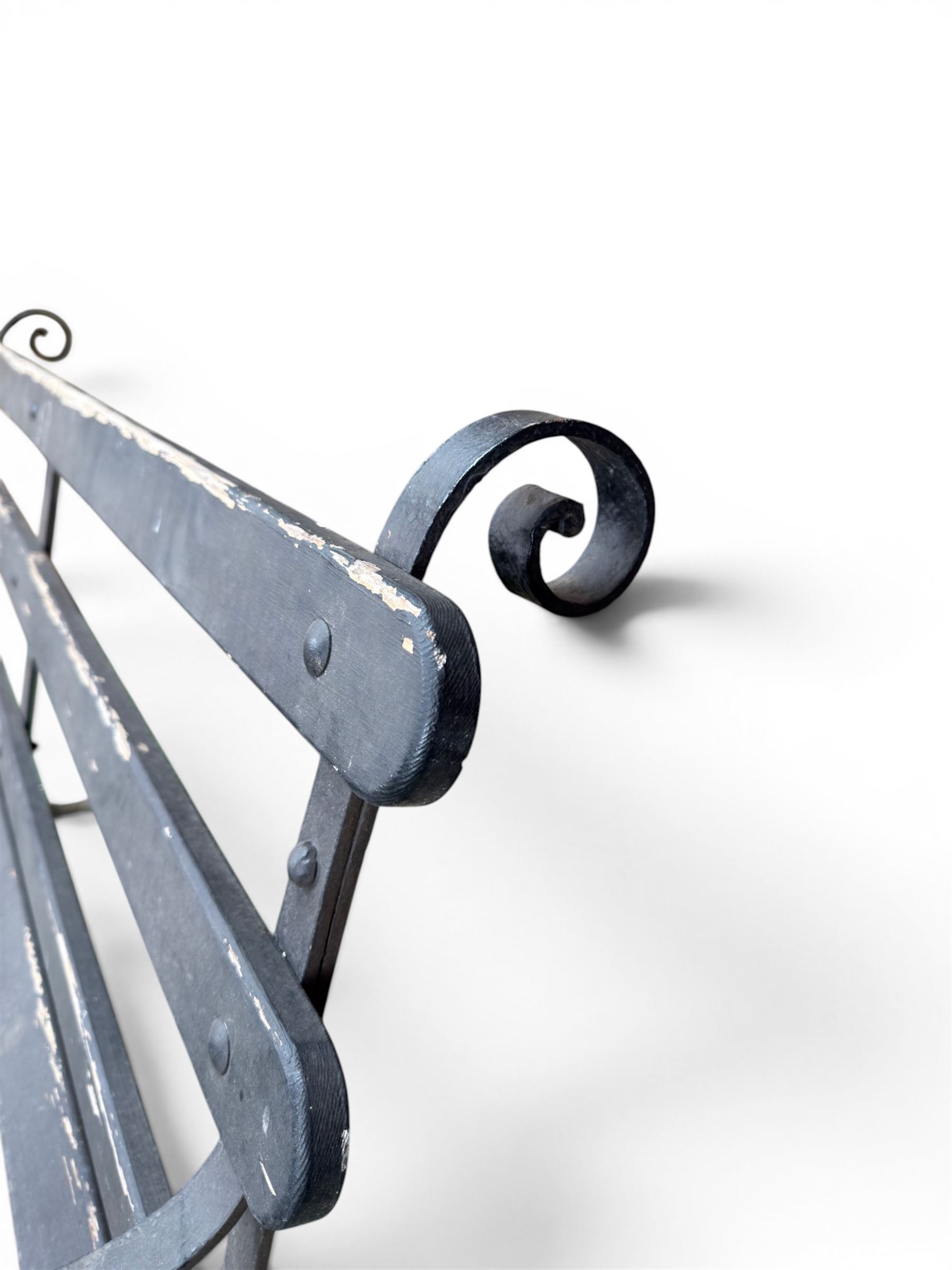 Coalbrookdale - rare pair of wrought iron and slatted wood garden benches, the twin wrought iron strapwork bench-ends formed of four scrolls over splayed feet, number 77 in the Coalbrookdale Castings Catalogue (see illustration)