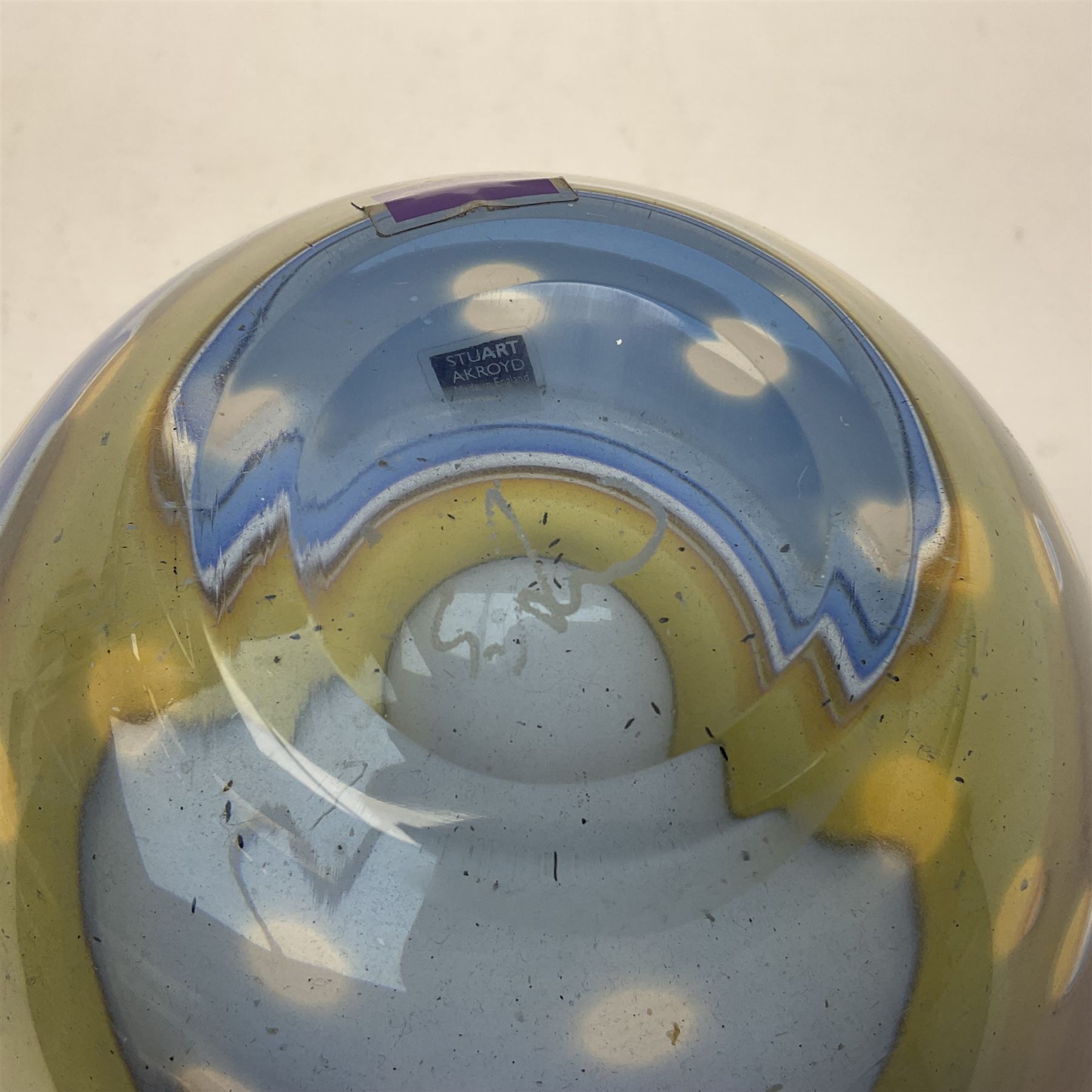 Stuart Akroyd glass vase, yellow banded top and blue lower section with bubble inclusions, with sticker and engraved signature beneath, H17cm
