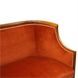 Edwardian inlaid mahogany tub two seater settee, traditional shape with satinwood stringing, upholstered in crimson fabric with sprung seat, on square tapering supports with castors