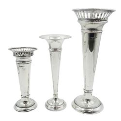 Three 20th century silver trumpet specimen vases, two examples with pierced rim and beaded detail to base, hallmarked Walker & Hall, Sheffield 1911, the third hallmarked G A Nock & Co, Birmingham 1967, tallest example H20cm, each with filled base 