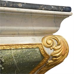 A 20th century Italian Neoclassical console table of architectural pedestal form, inspired by Roman architectural prototypes, with marble top and simulated marble scagliola-type finish; the rectangular marble top with grey veining within a black and yellow marble border, above a pedestal base finished in a finely executed faux-marble surface and enriched with parcel-gilt scrolling acanthus terminals, floral garlands, a central ribbon-tied motif in relief, and further raised flowerheads and a central gilt monogram, terminating in a stepped plinth base