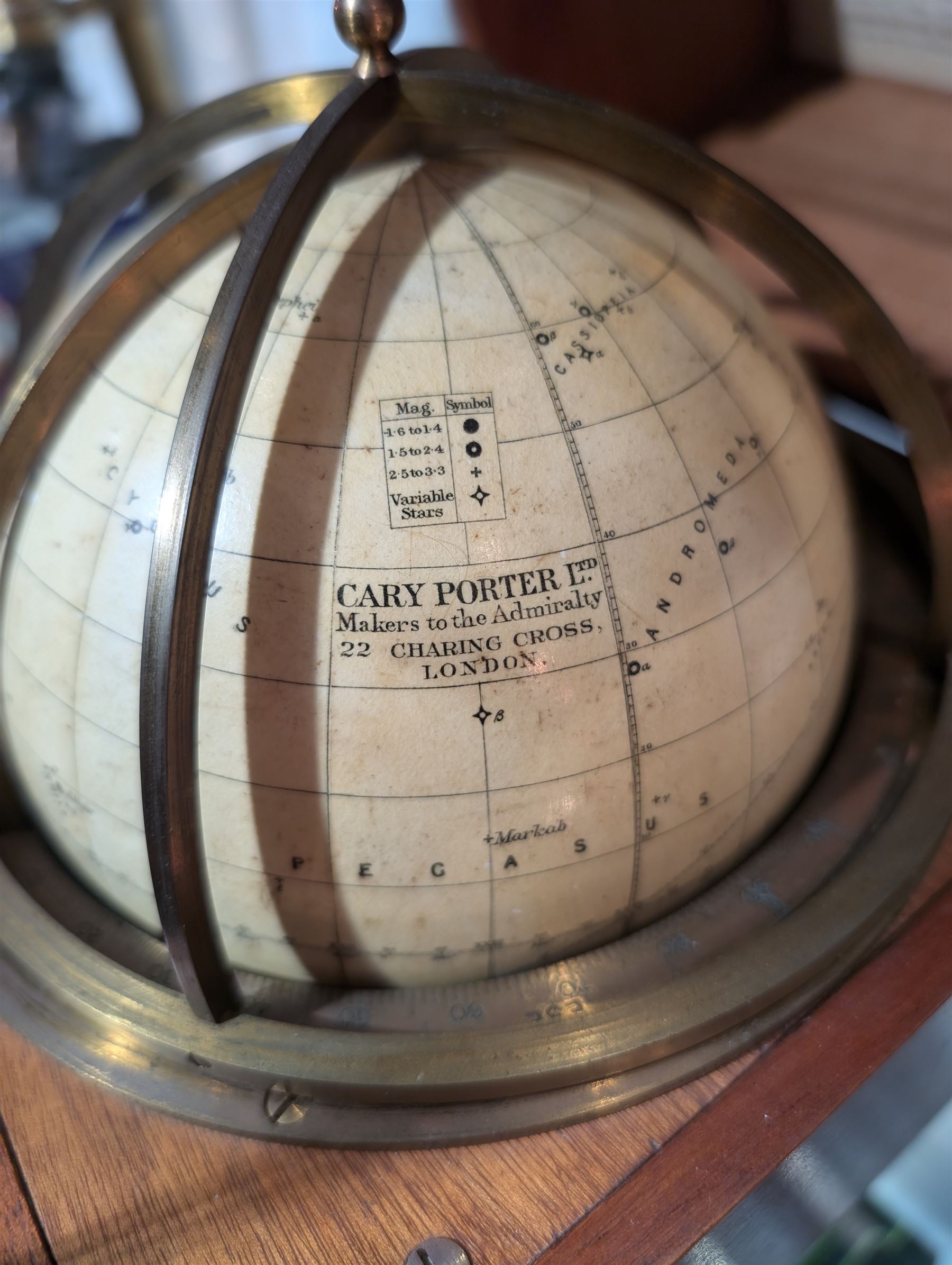 Cary Porter Ltd celestial navigational star globe patent no. 21450, the cream coloured sphere printed in black with stars and constellations, with brass meridian and horizon rings, contained within a fitted wooden box with paper instruction label to interior, globe diameter 11.5cm, box H21cm