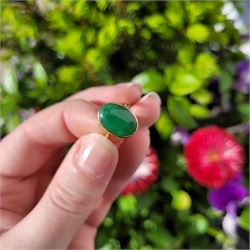 Early - mid 20th century gold jade ring, bezel set with a single oval cabochon jade of approx 4.10 carat, stamped 18ct