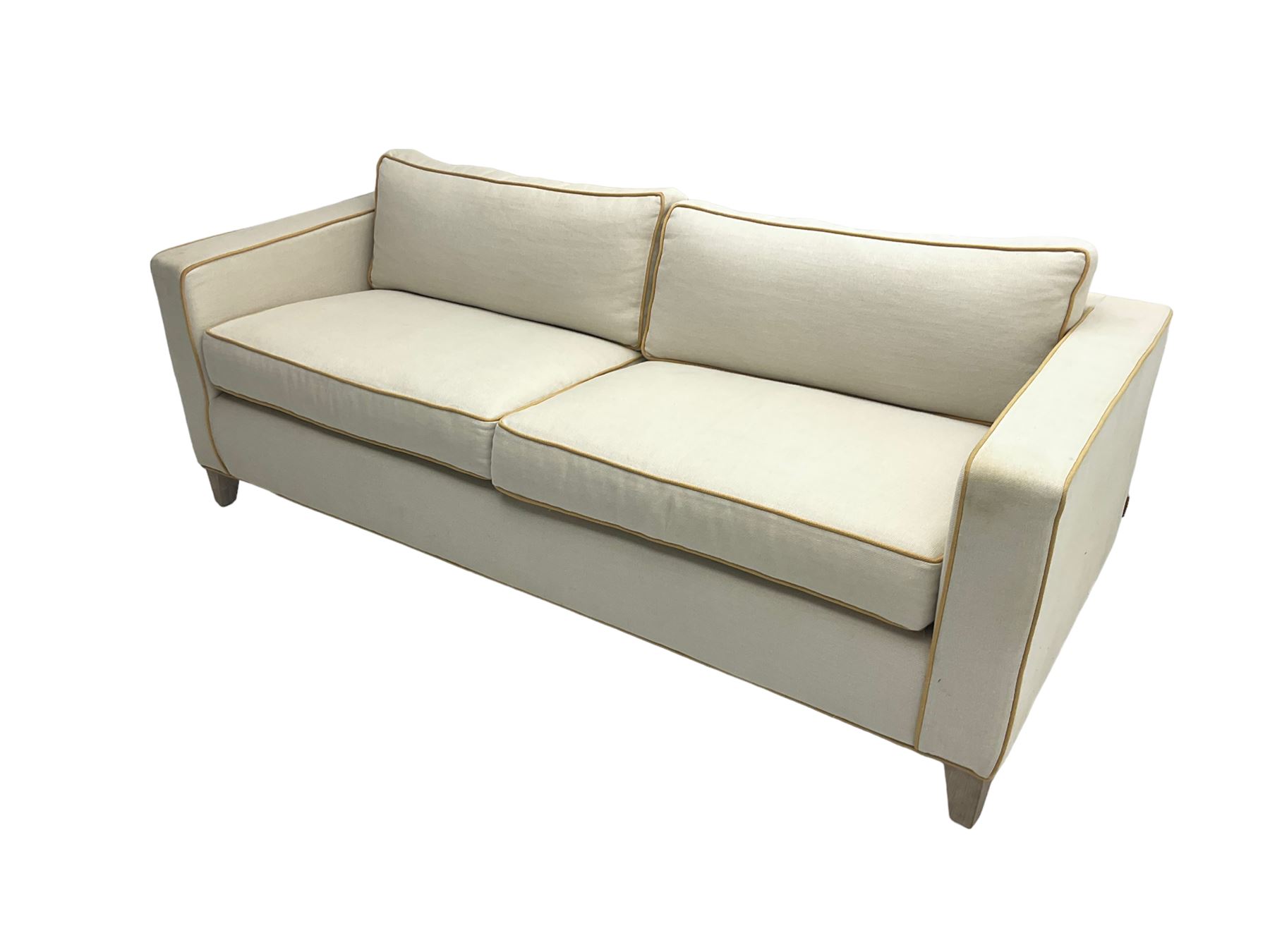 Neptune - pair three seat 'Shoreditch' sofas,  upholstered in cream fabric with yellow stringing